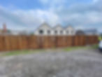 Long fence by housing estate