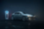 Electric car and charger against a dark background