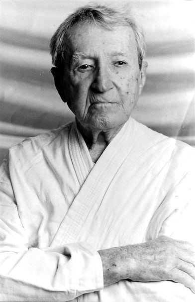 Black-and-white portrait of Carlos Gracie, one of the pioneers of Brazilian Jiu-Jitsu, wearing a gi.
