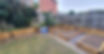 Backyard with new wooden garden beds, gravel path, grass, and a fence
