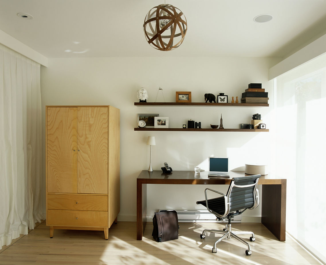 A Minimalist home office with a wooden desk and various decor items
