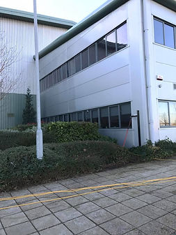 Side view of a modern industrial building with large windows