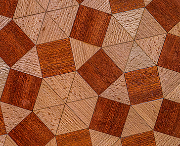 Détail des pièces géométriques de l’Operculum, assemblées en un motif de pavage avec différentes essences et nuances de bois.