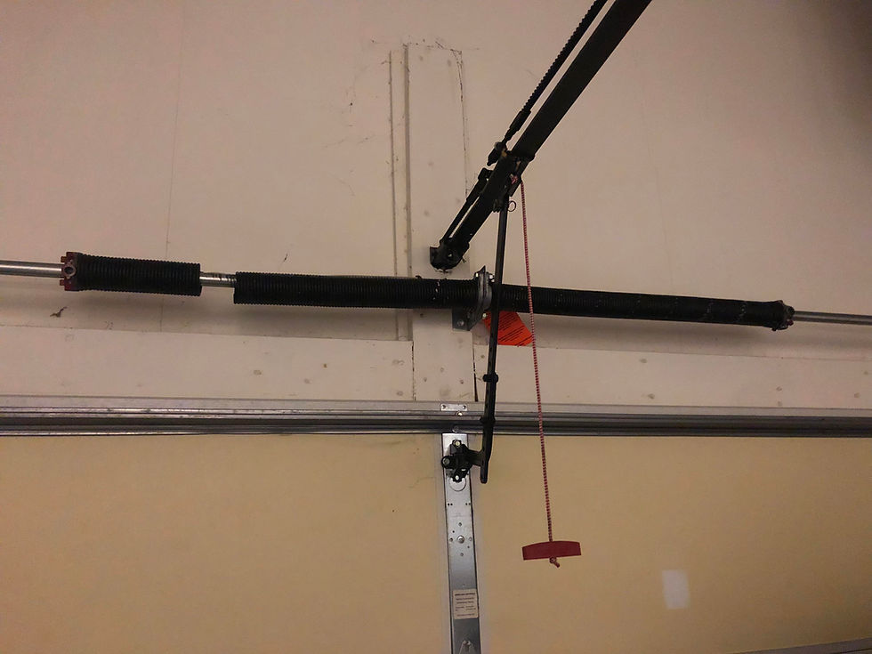 Broken torsion spring on garage doors now being repaired.