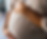 Close-up of pregnant woman holding her baby bump in a soft-lit room