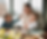 Dad sitting at a table eating with two young children in a family kitchen