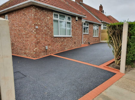 Black Tarmac® around a house with red brick edges