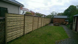 New wooden fence panels installed