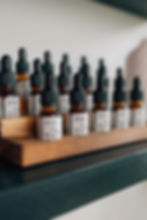 Essential oil bottles on a small wooden shelf