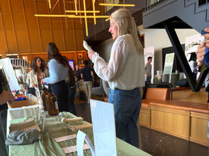 Attendees engaging in a high-end mobile apothecary scent blending activation at a 2026 corporate conference