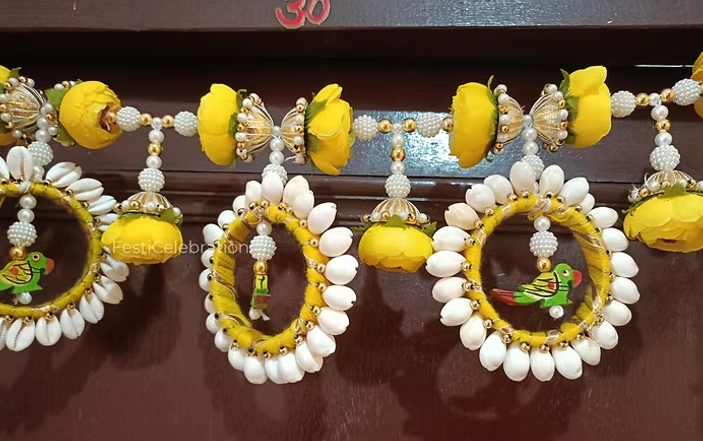 Thumbnail: Colorful floral toran with cowrie shells
