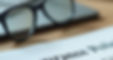 High angle view of a calculator and insurance forms on a desk