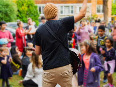 View of Shawny from behind, facing a crowd of children