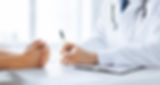 close up of patient and doctor taking notes.jpg
