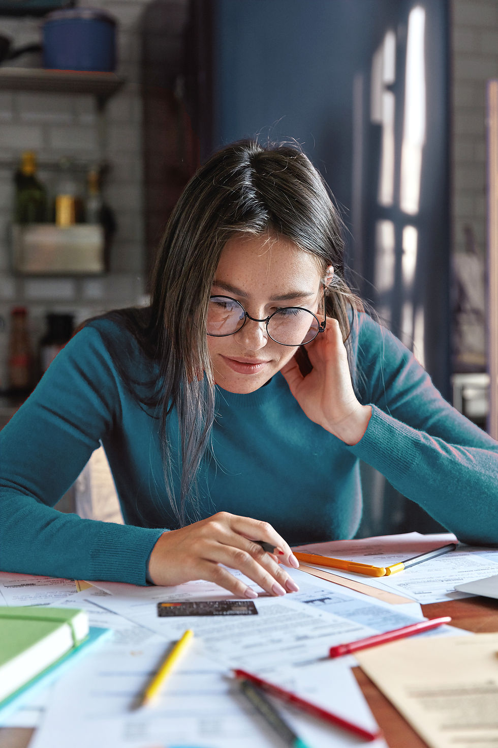 vertical-shot-freckled-brunette-young-woman-sits-home-with-credit-card_edited.jpg