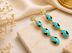 Luxury demi fine gold earrings with turquoise and black enamel details displayed on a marble surface, representing premium Demi Fine Gold Jewelry Wholesale India by Jewels Desire.