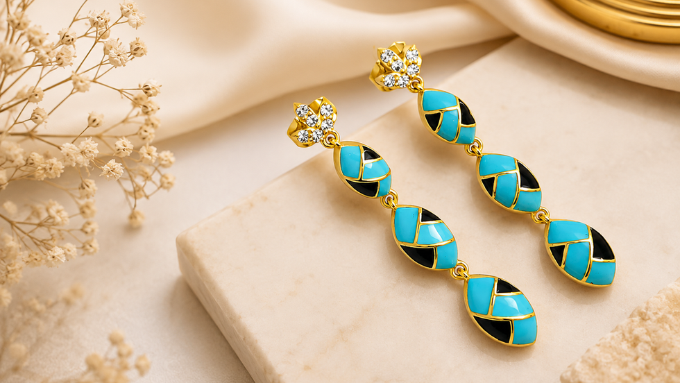 Luxury demi fine gold earrings with turquoise and black enamel details displayed on a marble surface, representing premium Demi Fine Gold Jewelry Wholesale India by Jewels Desire.