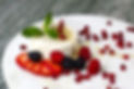 Plated dessert with fresh berries and whipped cream