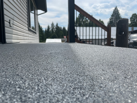 Close-up of a backyard sundeck with a high-gloss polyurethane coating, showcasing a durable, weather-resistant finish.
