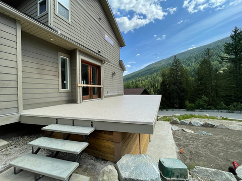 Freshly coated backyard sundeck with a waterproof polyurethane finish, offering durability and weather resistance.