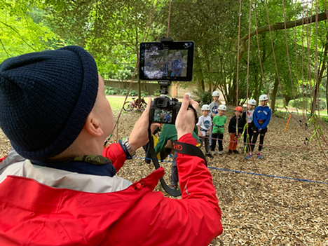 Man filming tree climbing