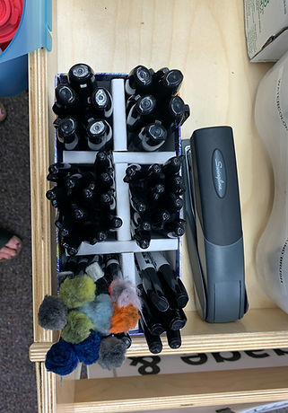 stapler and selections of sharpies, dry-erase markers with pom-pom erasers.JPG