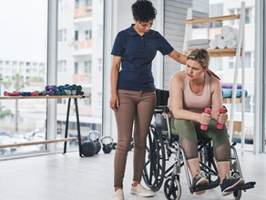 woman in wheelchair with physiotherapist