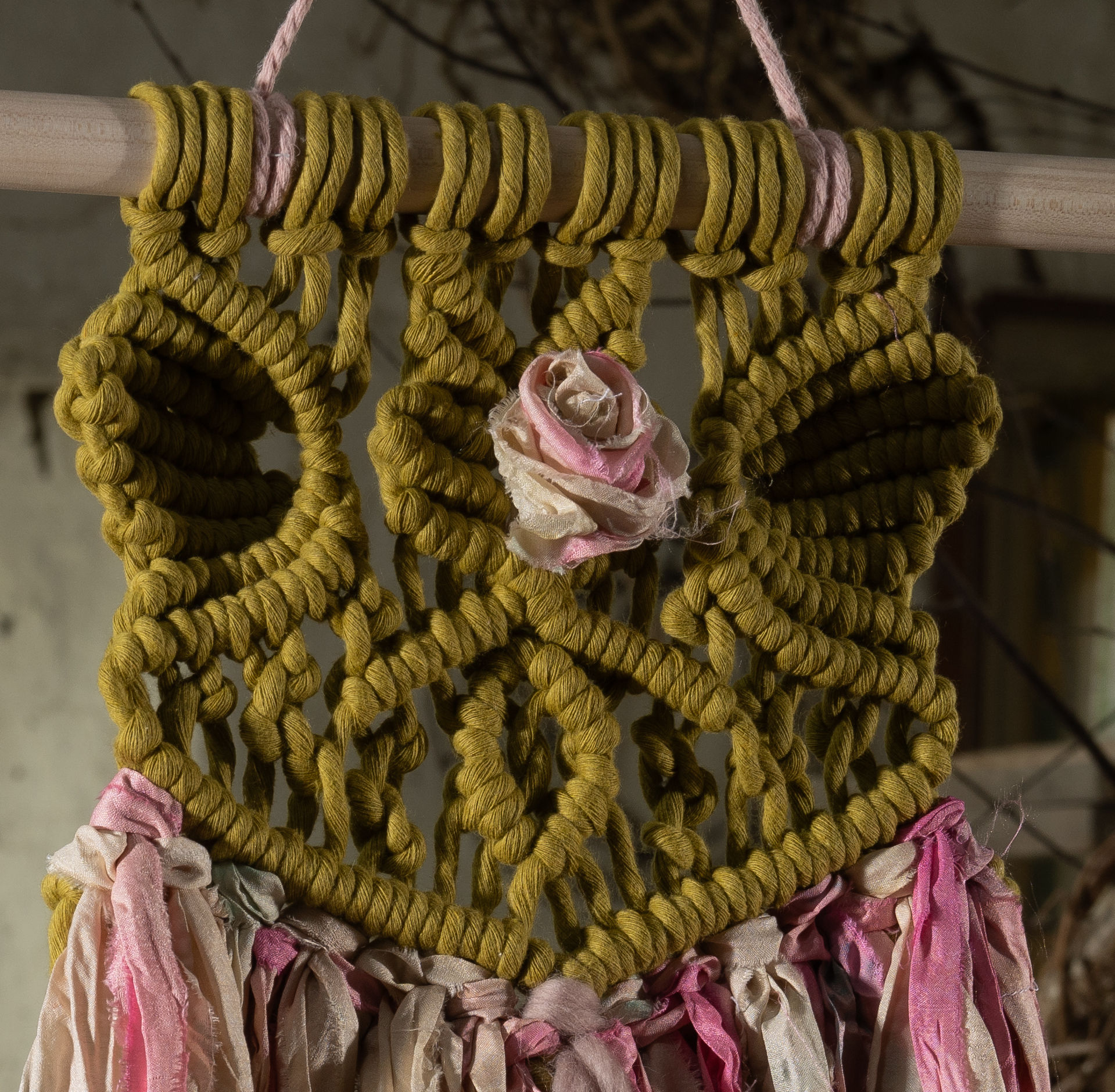 'Olive Rose' is a handmade piece of wall art by Lake District Artist Karen Morgan. This textural piece features sculpted elements with a hand-crafted rose made of silk Indian saris incorporated into the intricately patterned centre piece.