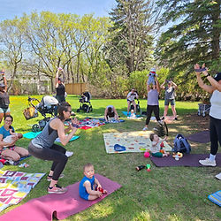 Group yoga class outdoors postnatal
