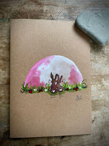 illustration of two hares beneath a pink moon with strawberrieshand painted Kraft card