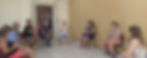 Três pessoas sentadas em círculo em uma sala de reuniões.