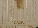 Delicate sterling silver Basic Collection chains hanging on a wooden display