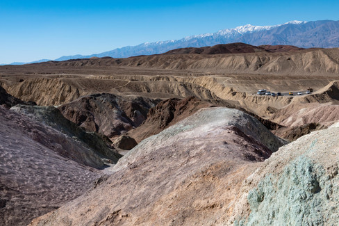 Scenic photograph of the colorful hills and parking area at Artist's Palette located along Artist's Drive in Death Valley National Park, California.