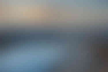 View of the creek, boardwalk, and mounains at sunset at the Salt Creek Interpretive Trail in Death Valley National Park, California