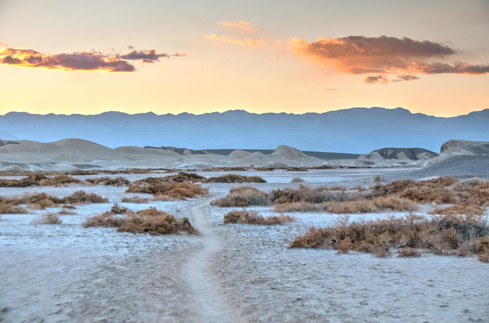 View of the salt flats and mounains at sunset at the Salt Creek Interpretive Trail in Death Valley National Park, California