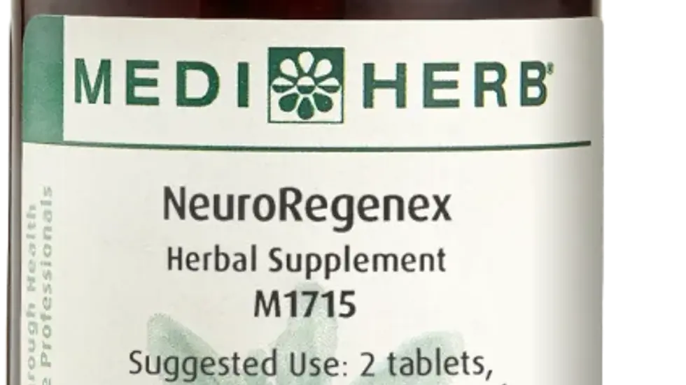 Eye-level view of a bottle of Standard Process supplements on a wooden table