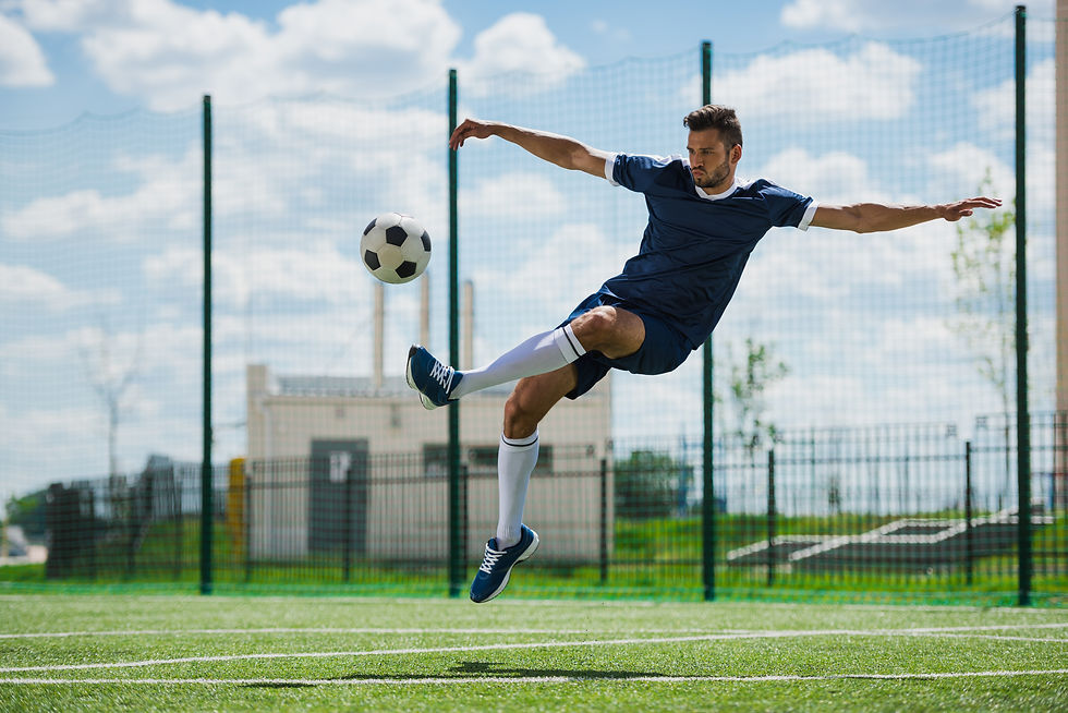 athletic-soccer-player-kicking-ball-on-soccer-pitc-WN5W3U9.jpg