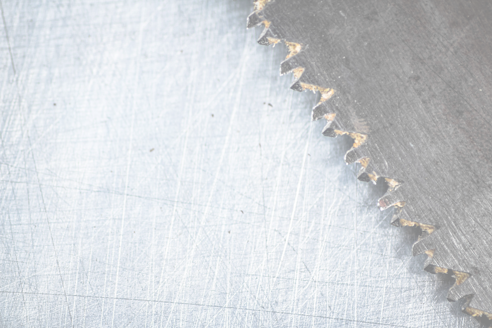 the-blade-of-a-hand-saw-on-a-gray-background-2022-01-12-05-07-32-utc_edited.png