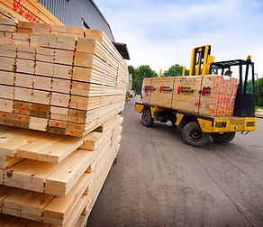 Image of lumber being loaded on delivery truck.