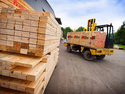 Image of lumber being moved with fork-lift truck.