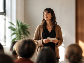 Woman speaking calmly to a small audience while building confidence