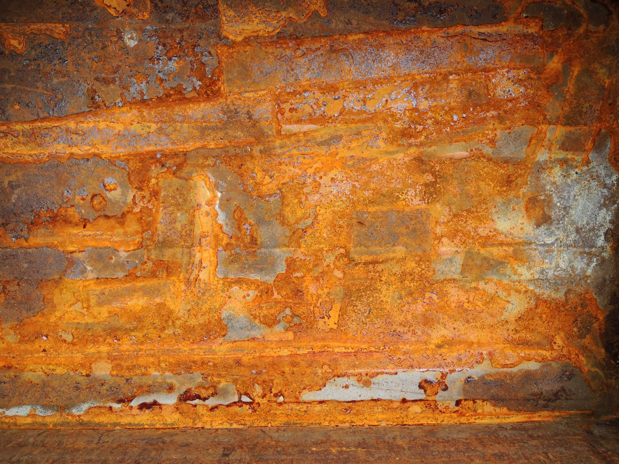 Close-up of corroded wall tie damage in UK brickwork — cavity wall tie failure sign