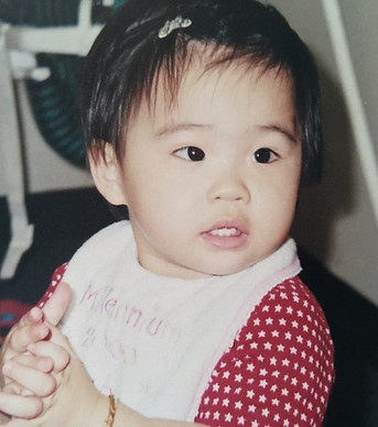 Baby Tayler Nhi Vo wearing a red outfit with white stars and a bib.