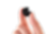 In-the-ear hearing aid shown held in finger tips