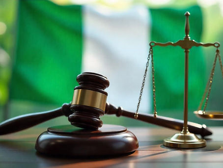 Nigeria's green-white-green national flag in the background. In the foreground are clear images of a police truncheon, the scales of justice, and a legislative mace