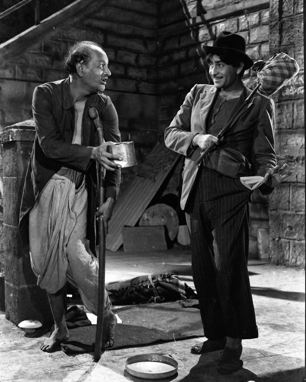 a black and white photo of two men standing next to each other