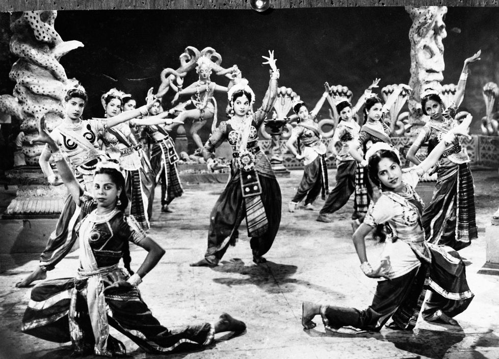 a black and white photo of a group of women dancing