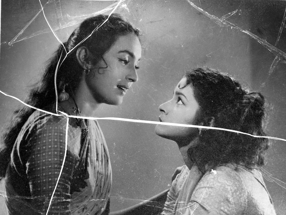 a black and white photo of two women looking at each other