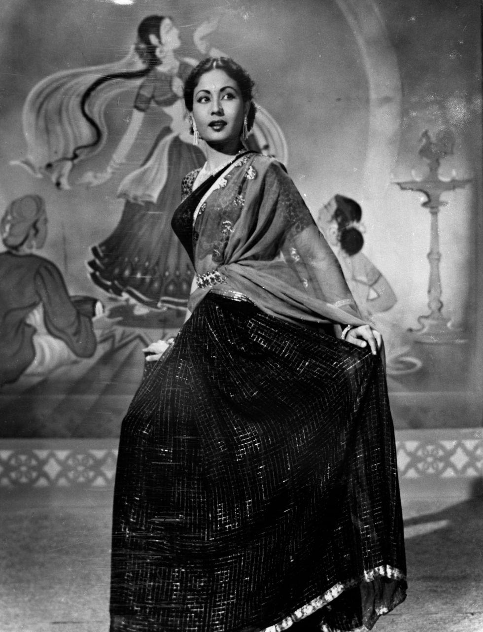 a black and white photo of a woman in a saree