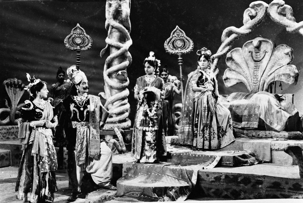 a black and white photo of a group of people in costumes